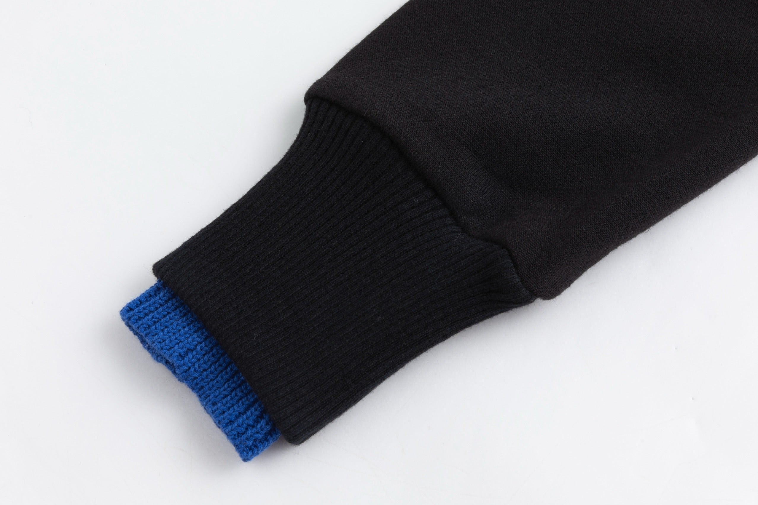 Black Sweater With Green And Blue Knit Pocket Details