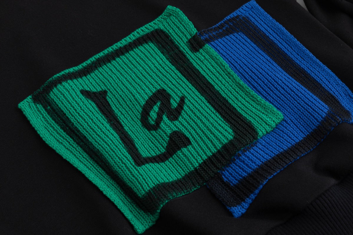 Black Sweater With Green And Blue Knit Pocket Details